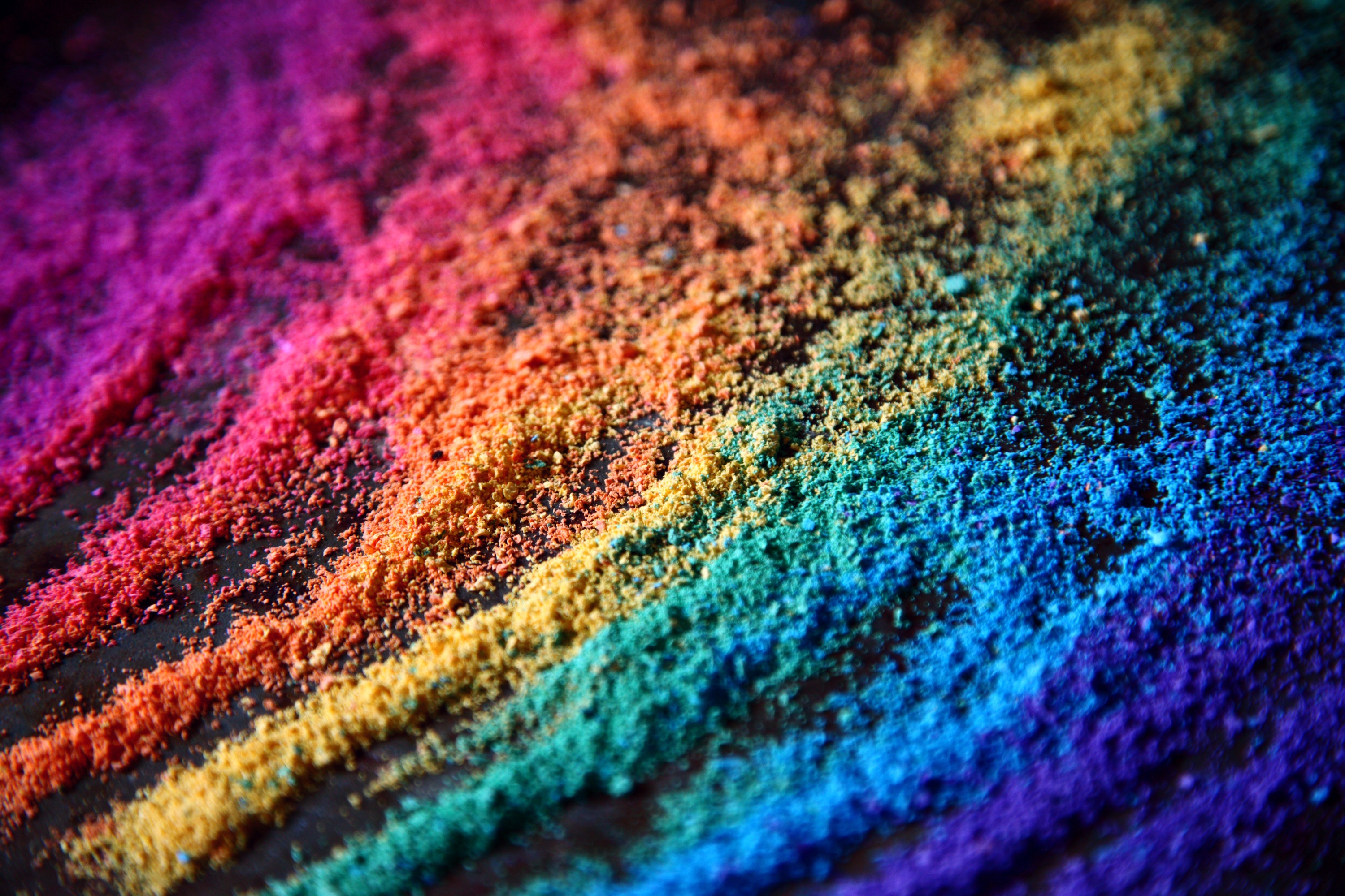 A photo of fine granules in the colors of the rainbow by Alexander Grey
