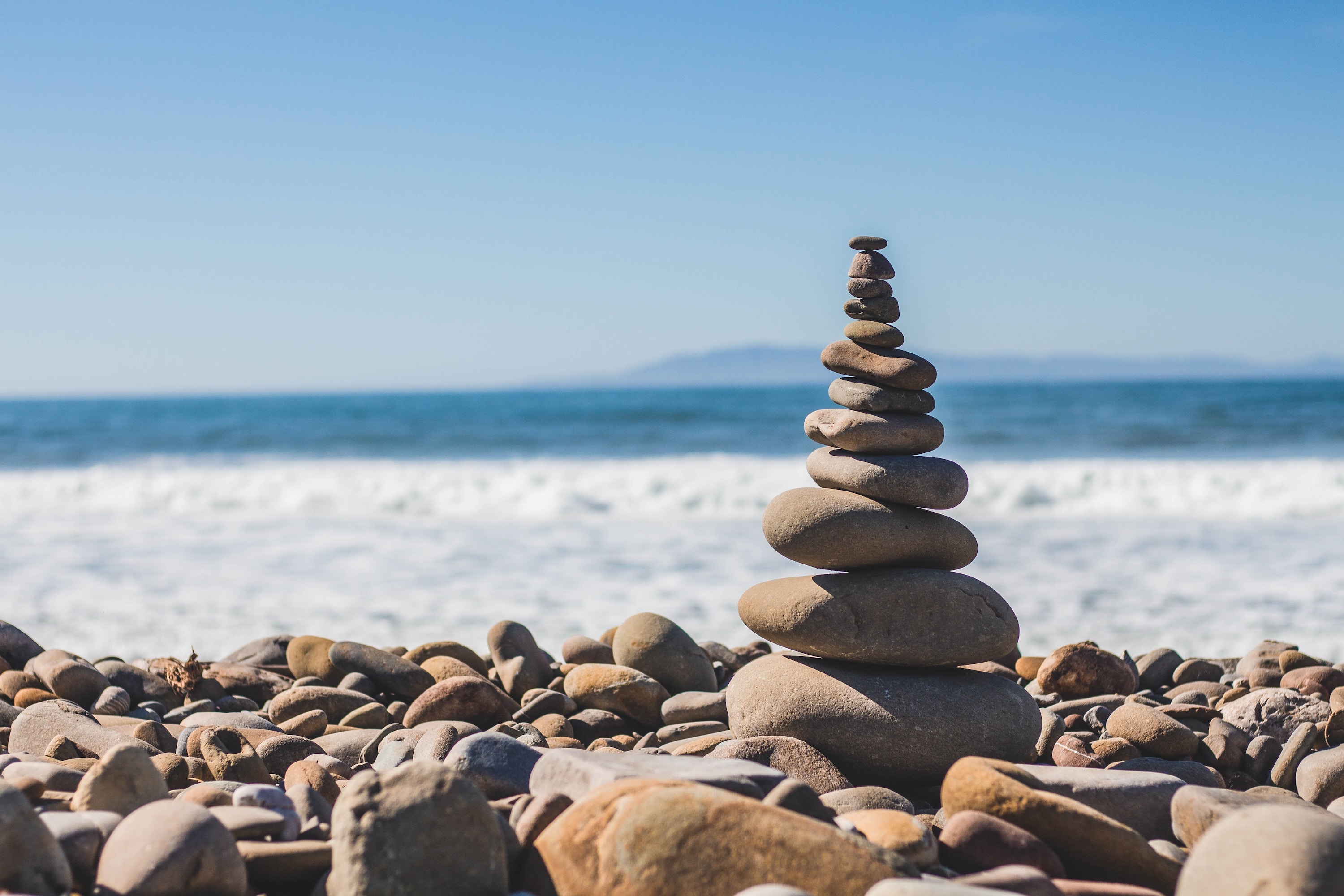 A photo of stacked rounded stones at the beach by Jeremy Thomas
